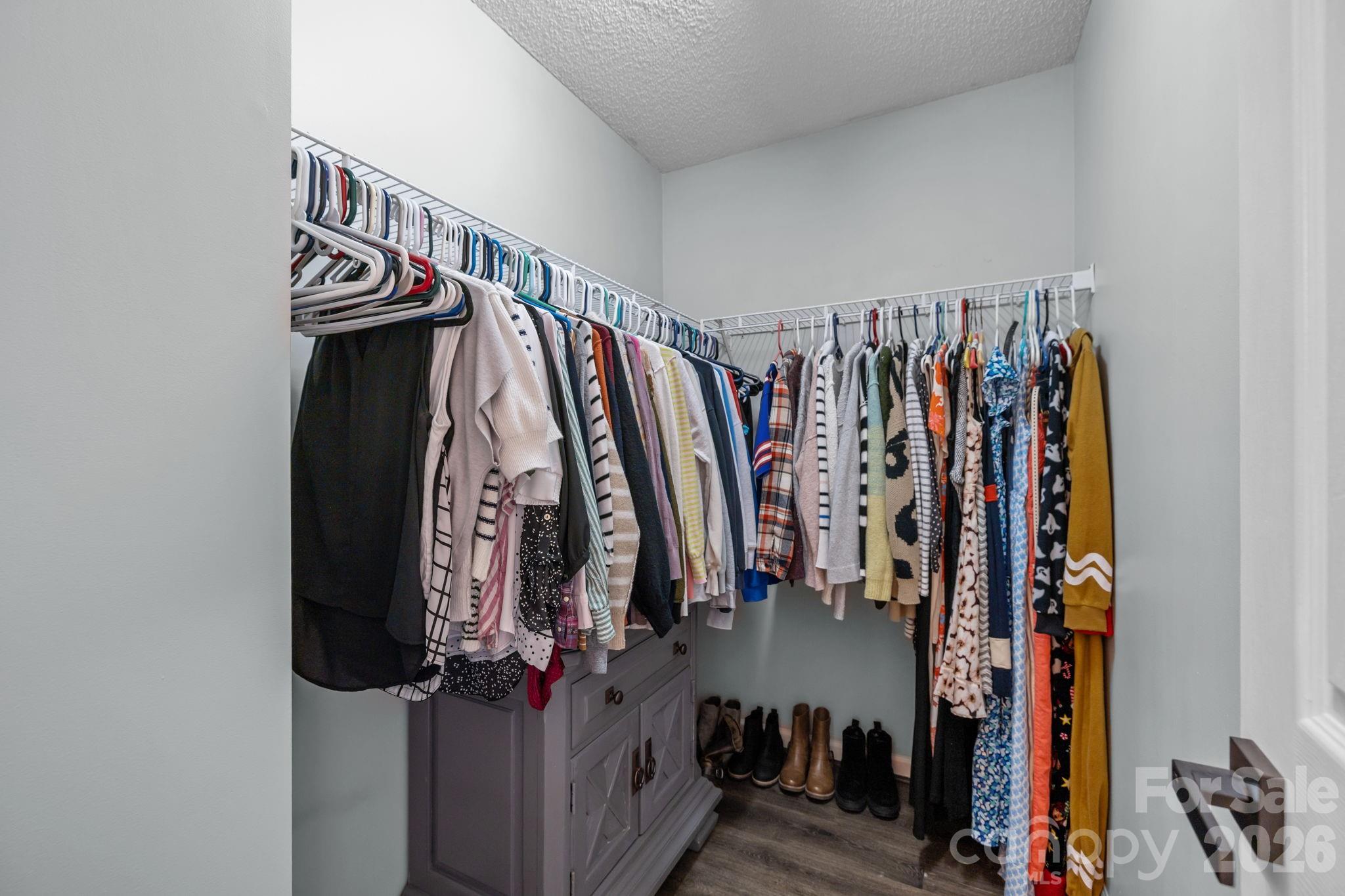 213 Butler Place Fort Mill, SC 29715 - Photo 18 of 36 a view of walk in closet with clothes
