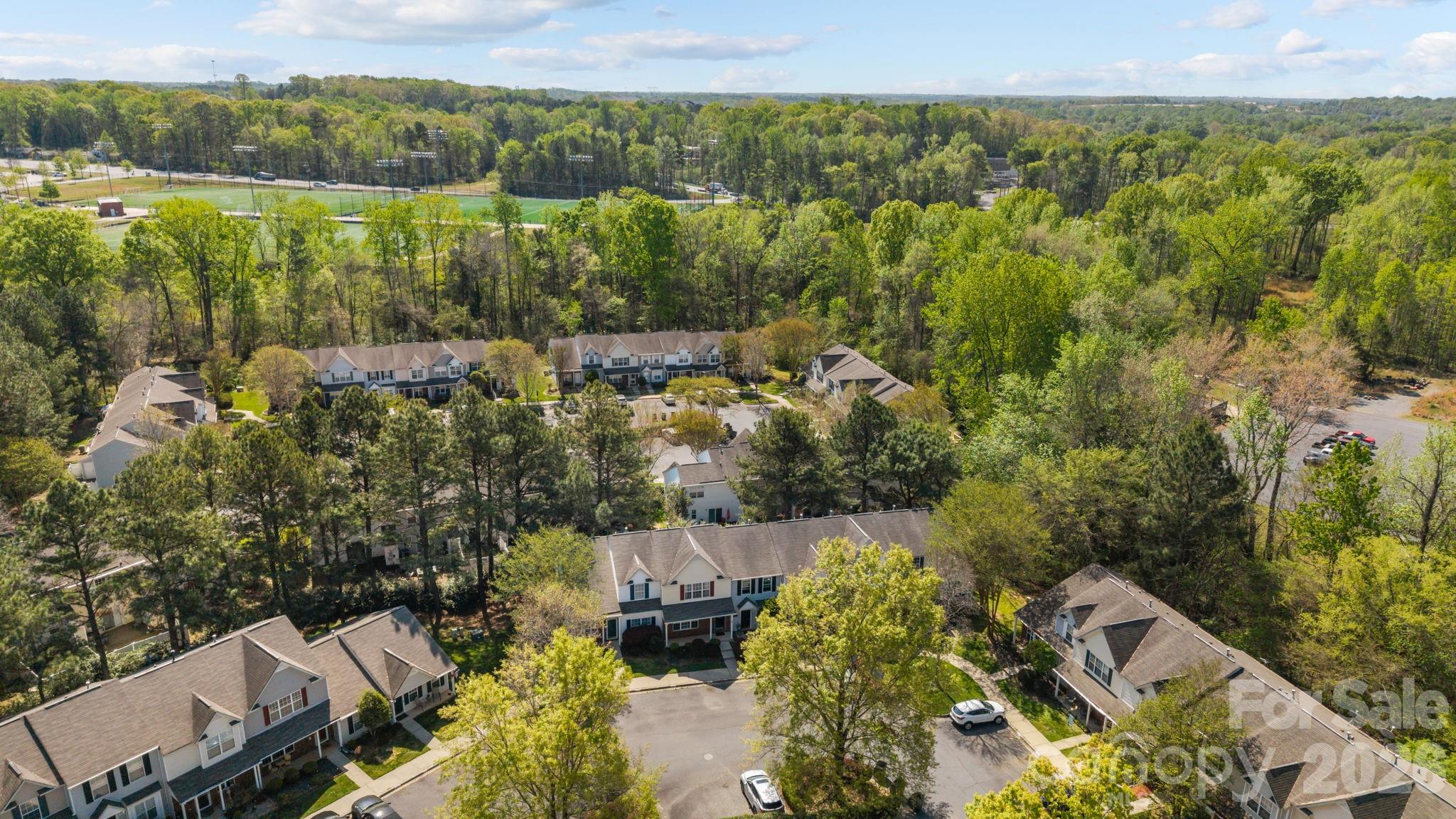 213 Butler Place Fort Mill, SC 29715 - Photo 29 of 36 an aerial view of residential houses with outdoor space and trees