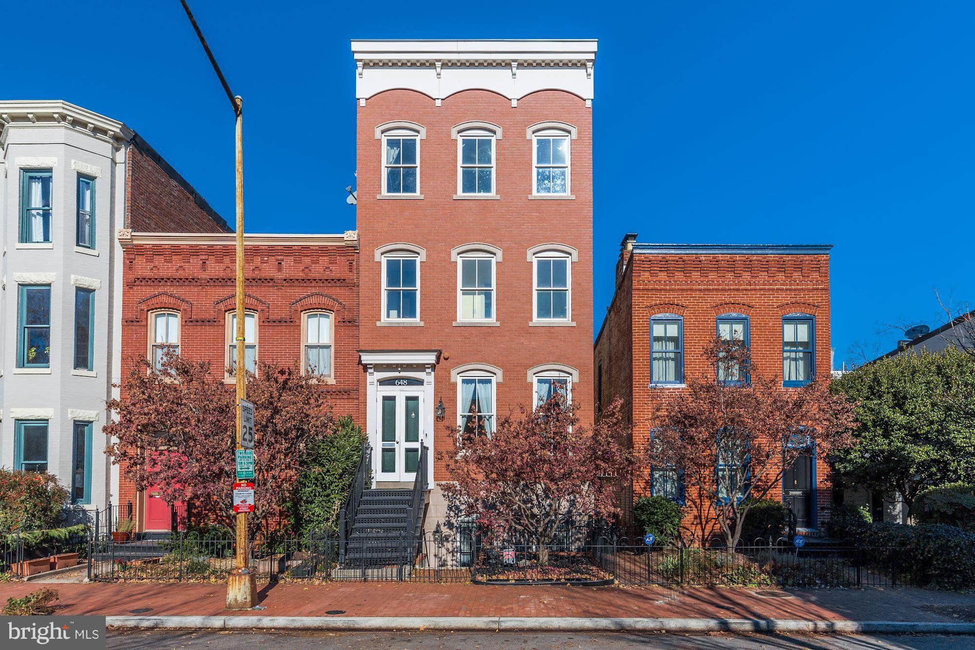 a view of a brick building next to a yard