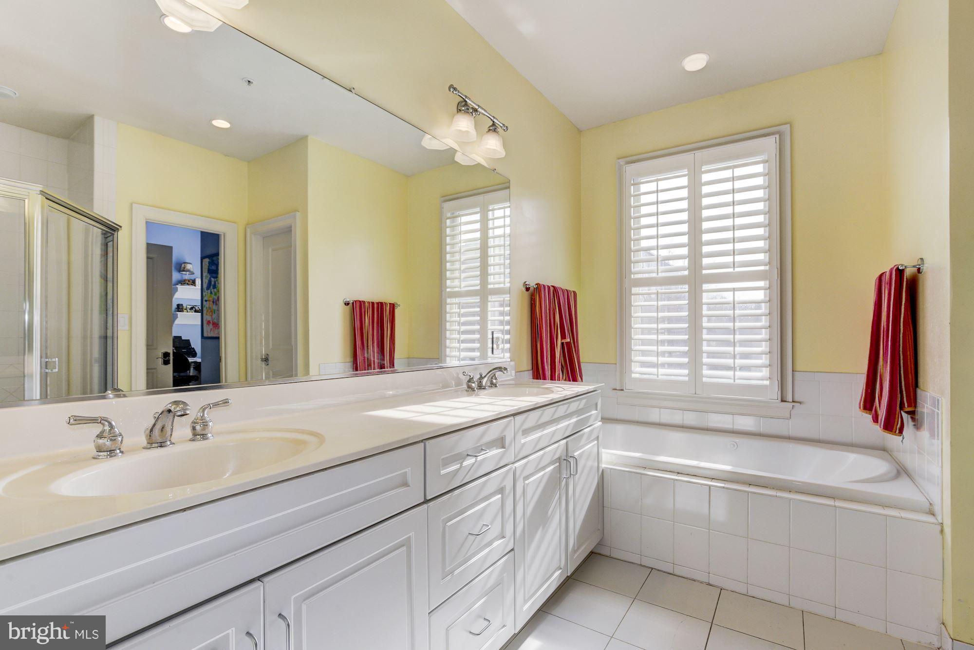 648 C Street Northeast Washington, DC 20002 - Photo 12 of 22 a bathroom with a granite countertop sink and a bathtub