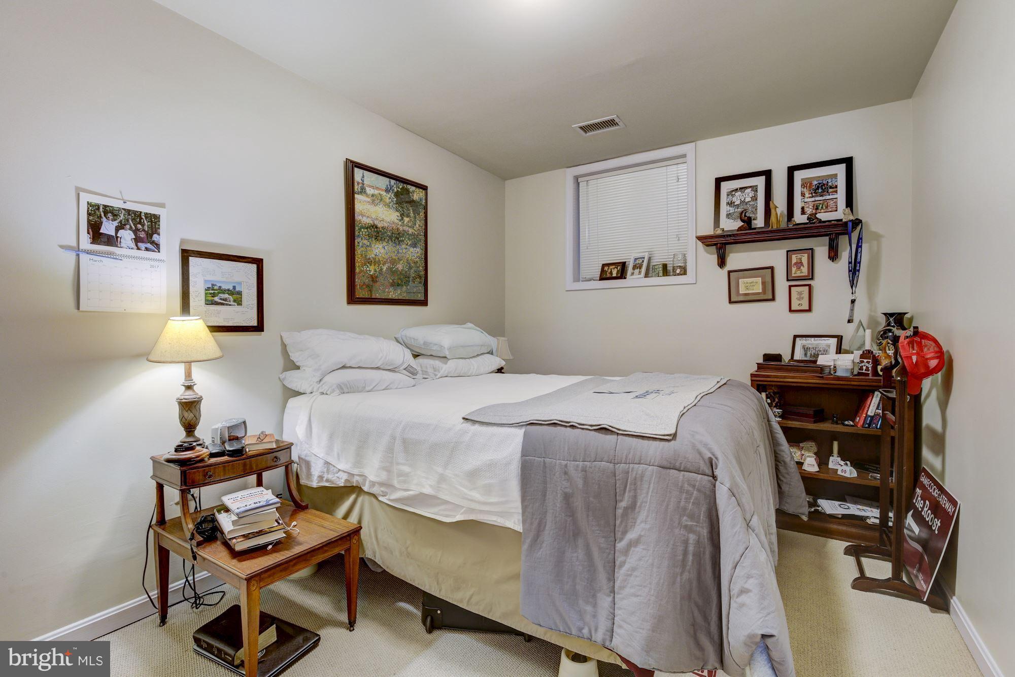 648 C Street Northeast Washington, DC 20002 - Photo 19 of 22 a bedroom with a bed and a chair in it