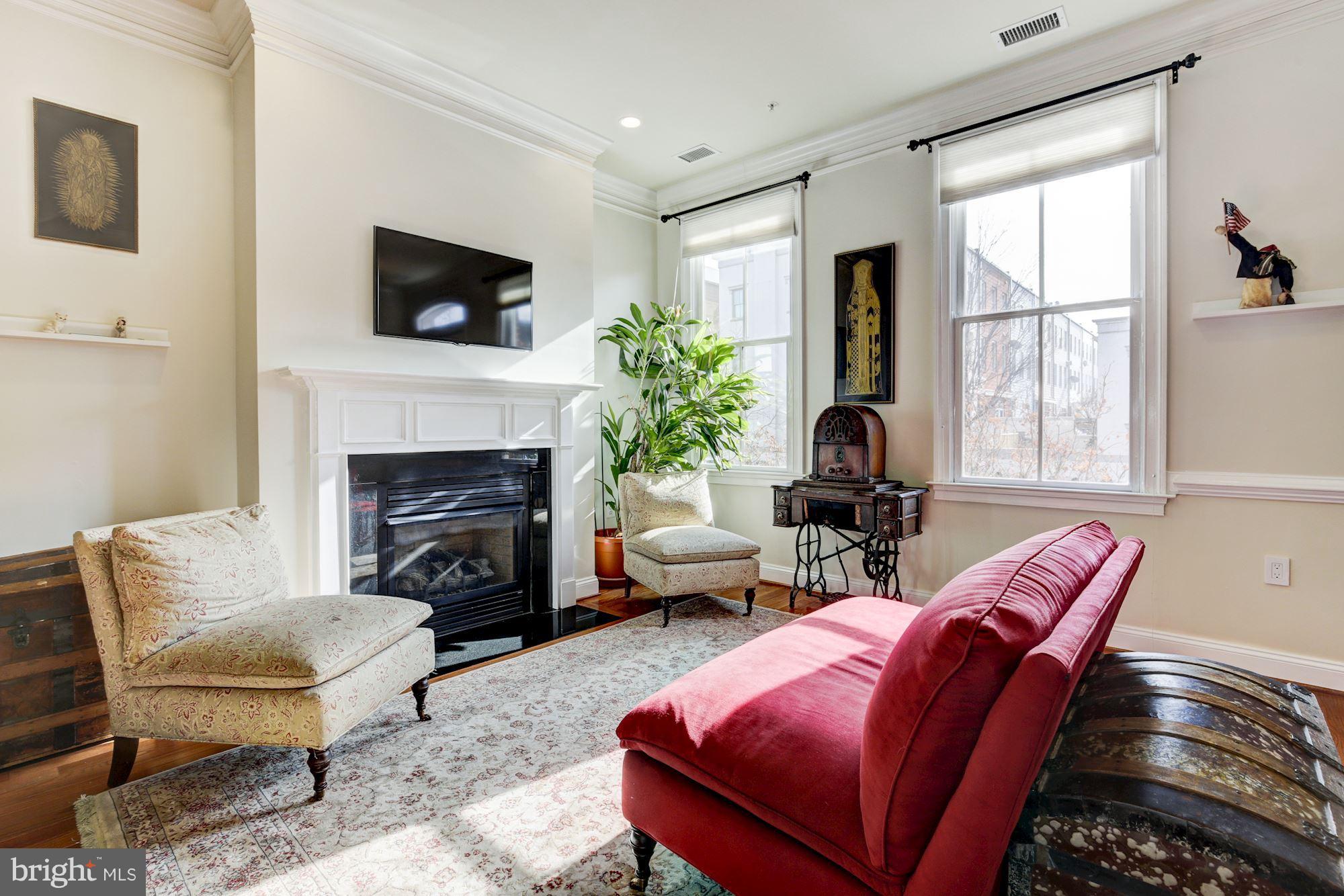 648 C Street Northeast Washington, DC 20002 - Photo 4 of 22 a living room with furniture a flat screen tv and a fireplace