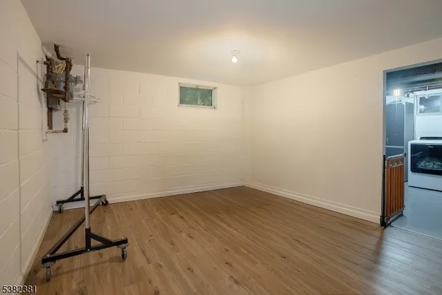 a view of a room with wooden floor and bathroom