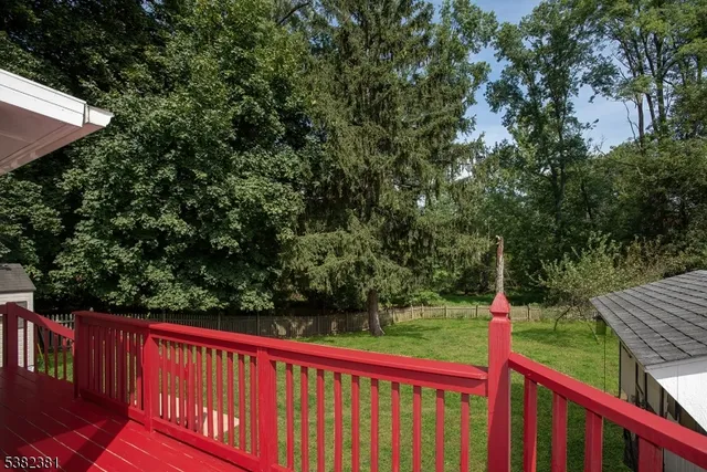a view of a balcony with wooden floor and fence