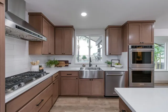 a kitchen with a sink a stove and cabinets