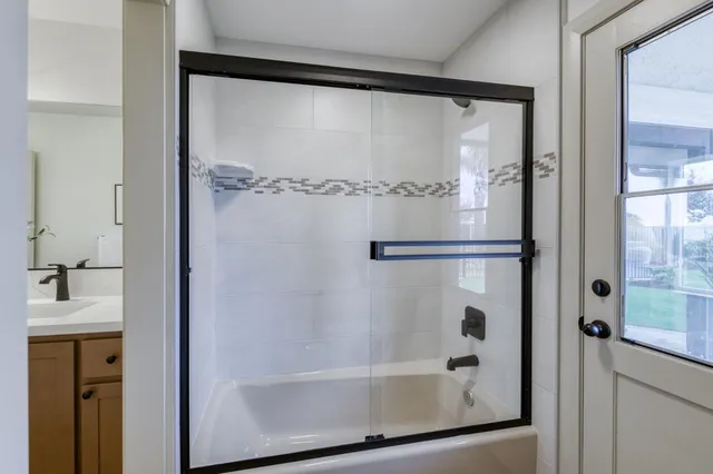 a bathroom with a glass shower door