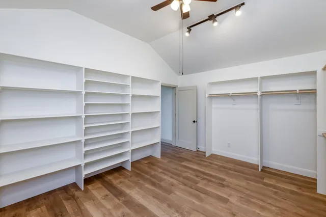 a view of room with empty cabinets and wooden floor