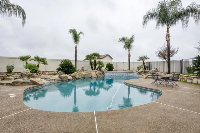 a view of a swimming pool with a table and chairs