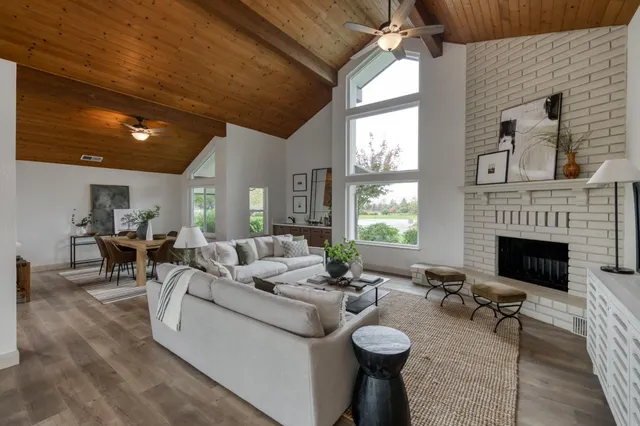 a living room with furniture a fireplace and a table