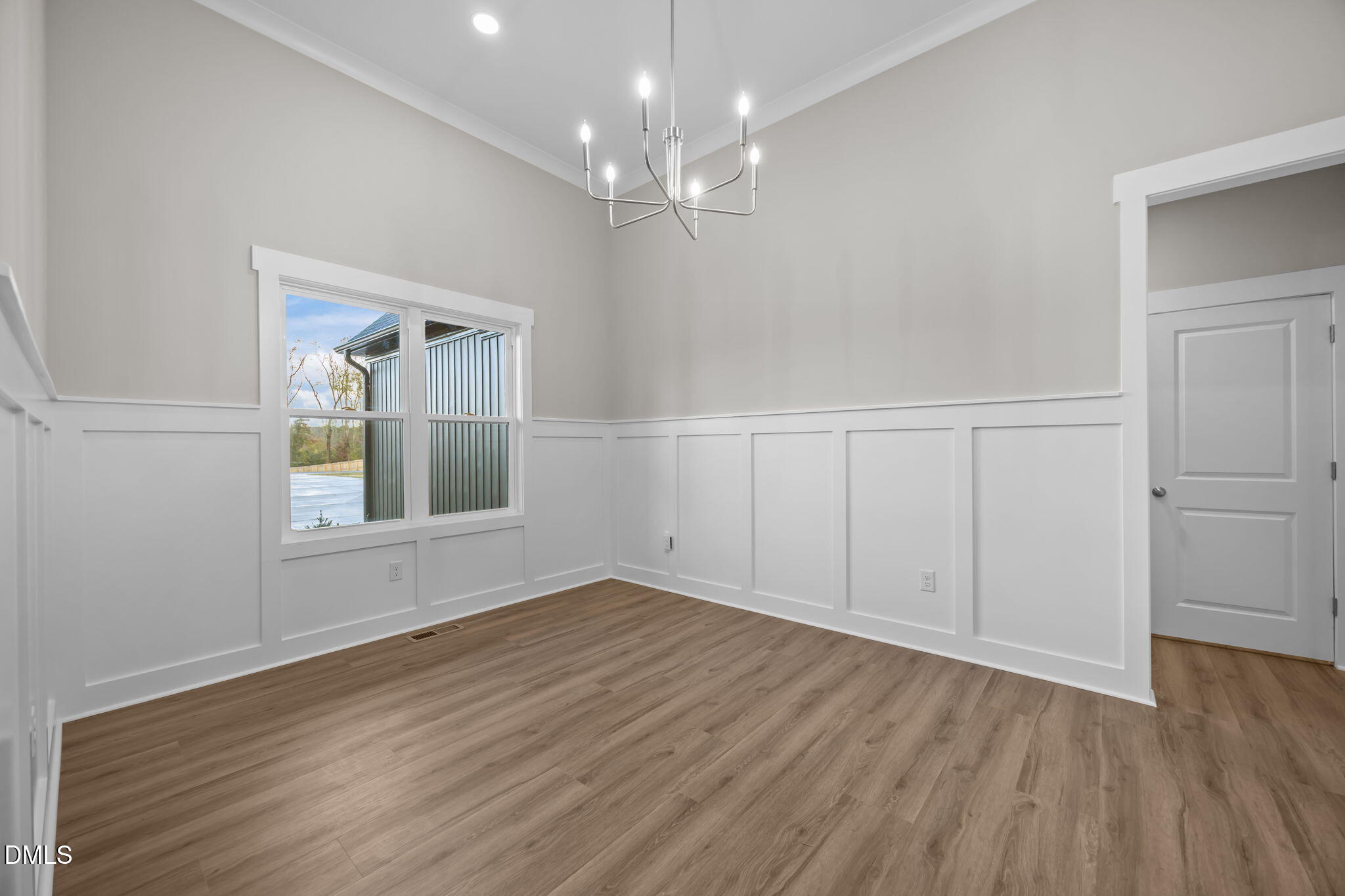 8629 Dukes Lake Road Zebulon, NC 27597 - Photo 12 of 52 a view of an empty room with wooden floor and a window