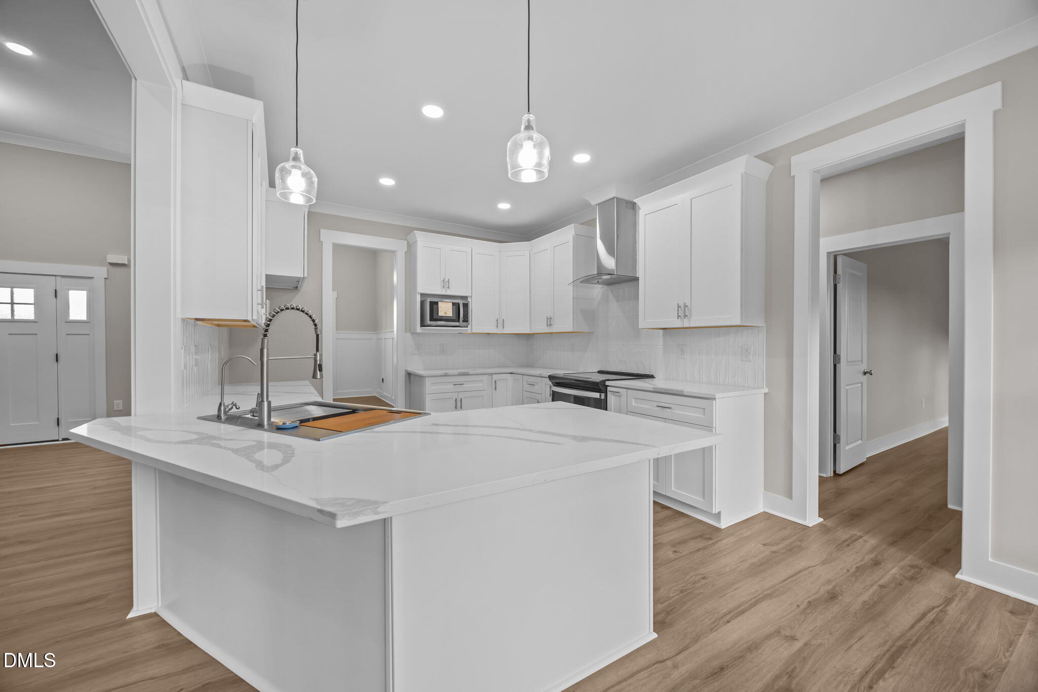 8629 Dukes Lake Road Zebulon, NC 27597 - Photo 14 of 52 a kitchen with kitchen island a sink stainless steel appliances and cabinets