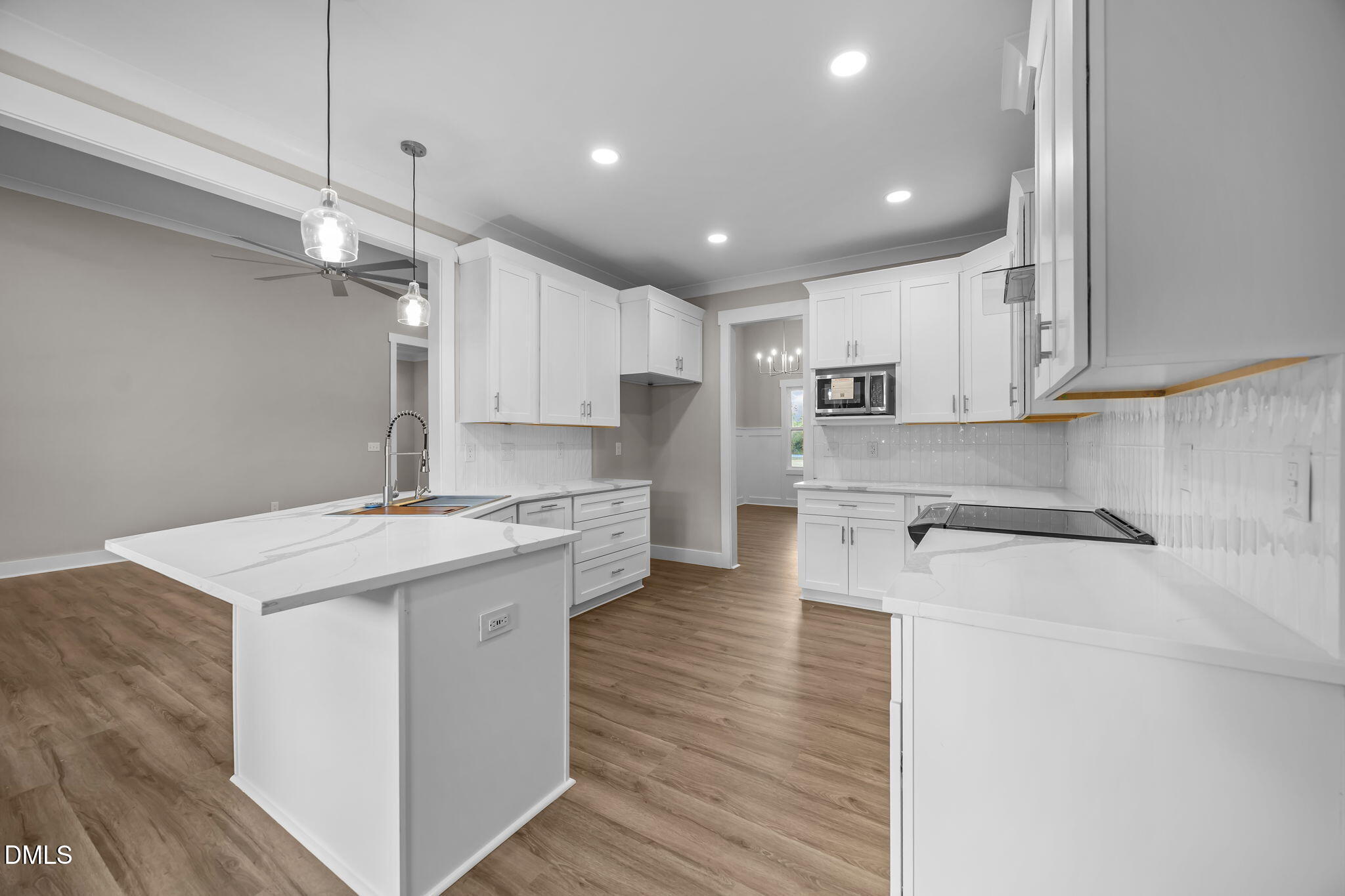 8629 Dukes Lake Road Zebulon, NC 27597 - Photo 15 of 52 a kitchen with kitchen island a sink stainless steel appliances and cabinets