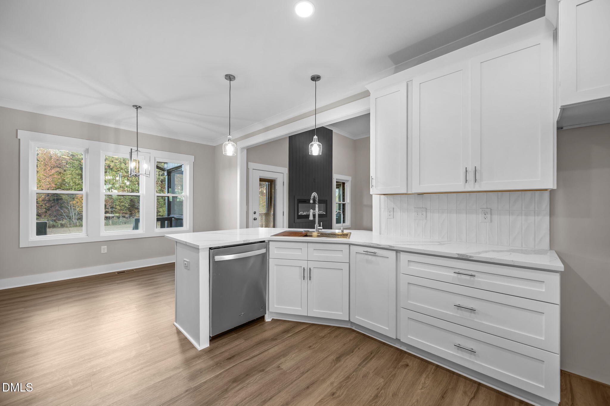 8629 Dukes Lake Road Zebulon, NC 27597 - Photo 16 of 52 a kitchen with stainless steel appliances granite countertop a stove a sink and white cabinets with wooden floor