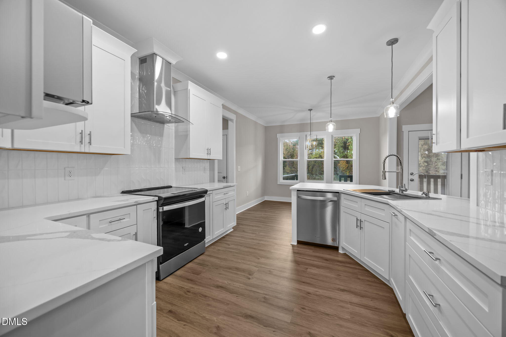 8629 Dukes Lake Road Zebulon, NC 27597 - Photo 17 of 52 a large kitchen with stainless steel appliances granite countertop a sink a stove and a wooden floors