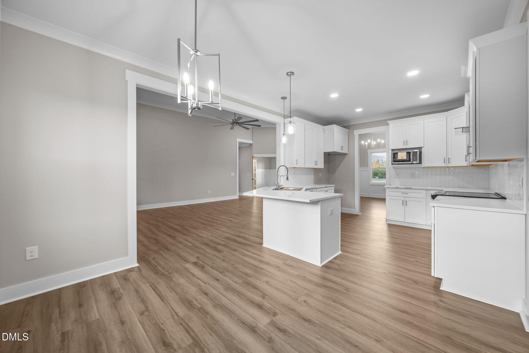 8629 Dukes Lake Road Zebulon, NC 27597 - Photo 18 of 52 a view of a kitchen with granite countertop wooden floor and a sink