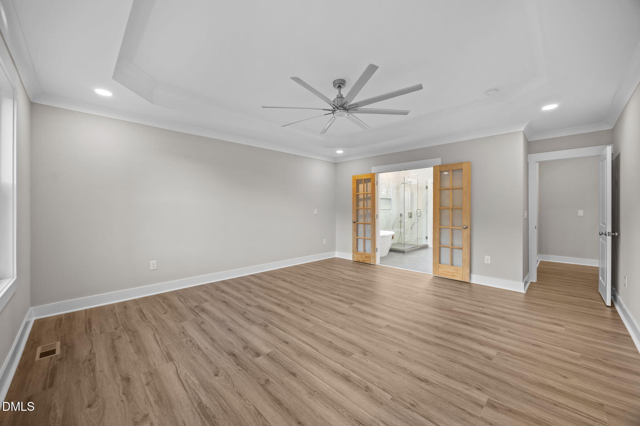 8629 Dukes Lake Road Zebulon, NC 27597 - Photo 21 of 52 a view of an empty room with wooden floor and a window