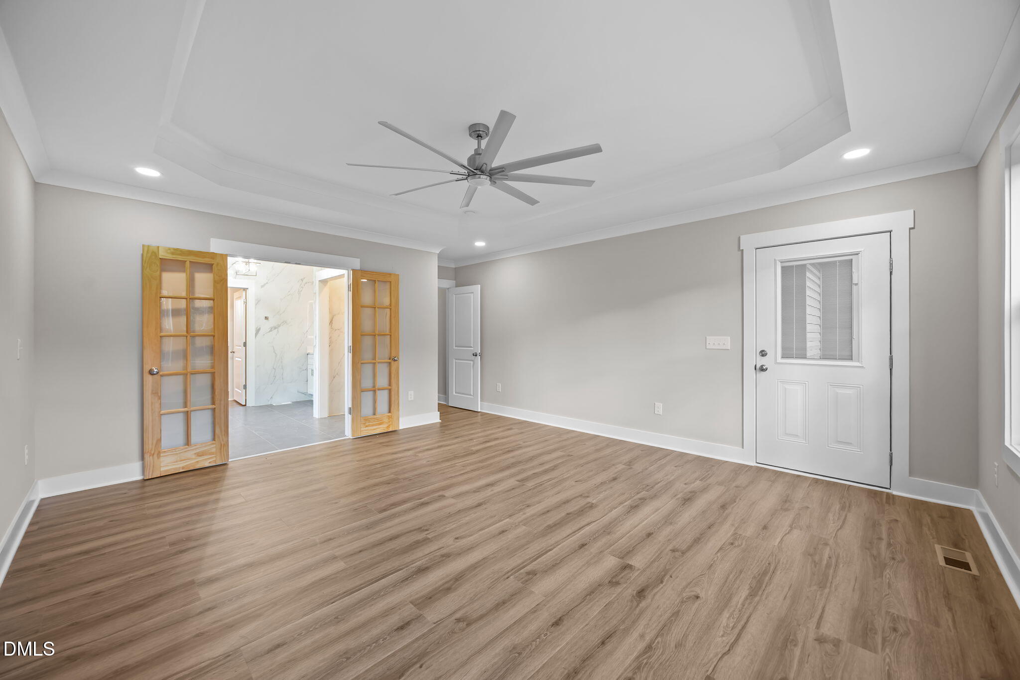 8629 Dukes Lake Road Zebulon, NC 27597 - Photo 22 of 52 a view of an empty room with wooden floor and a window