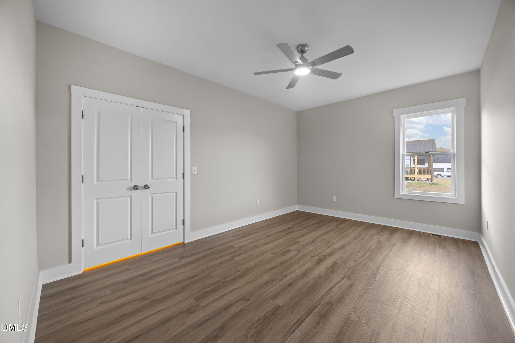 8629 Dukes Lake Road Zebulon, NC 27597 - Photo 28 of 52 a view of an empty room with wooden floor and a window