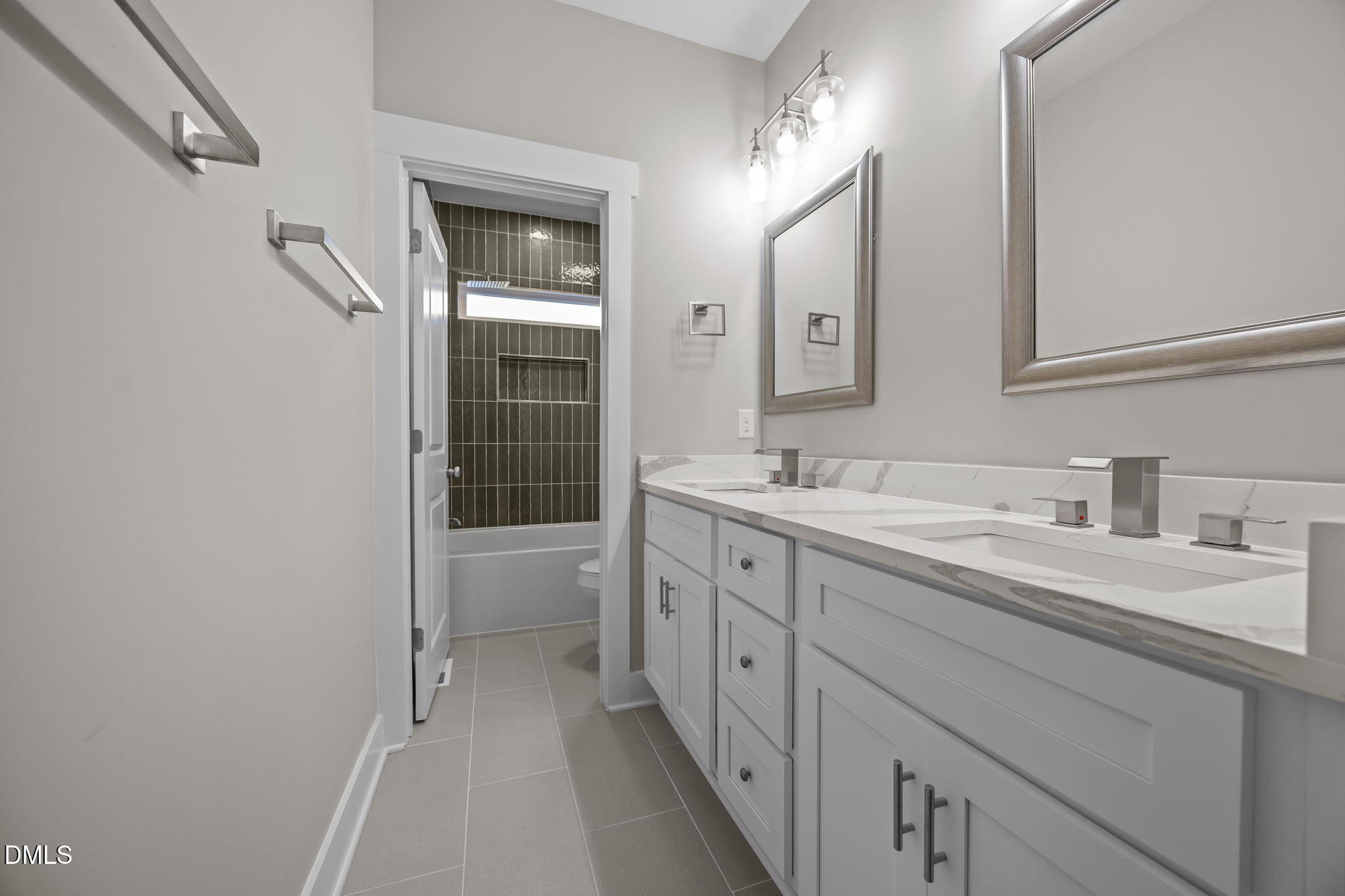 8629 Dukes Lake Road Zebulon, NC 27597 - Photo 29 of 52 a spacious bathroom with a double vanity sink a toilet and a mirror