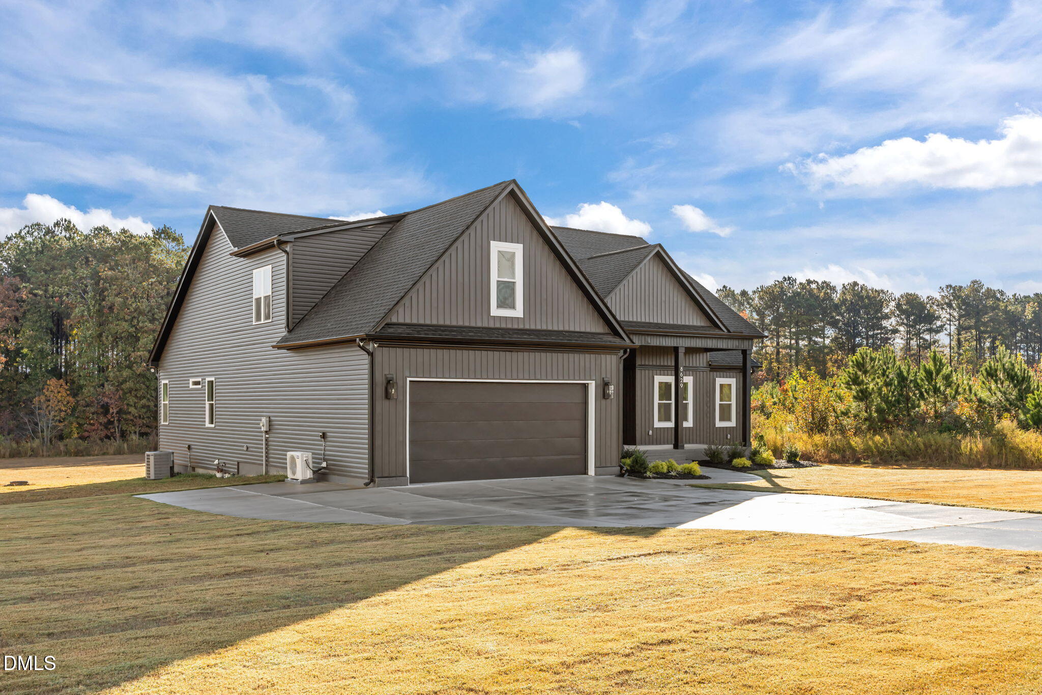 8629 Dukes Lake Road Zebulon, NC 27597 - Photo 3 of 52 a front view of a house with a yard