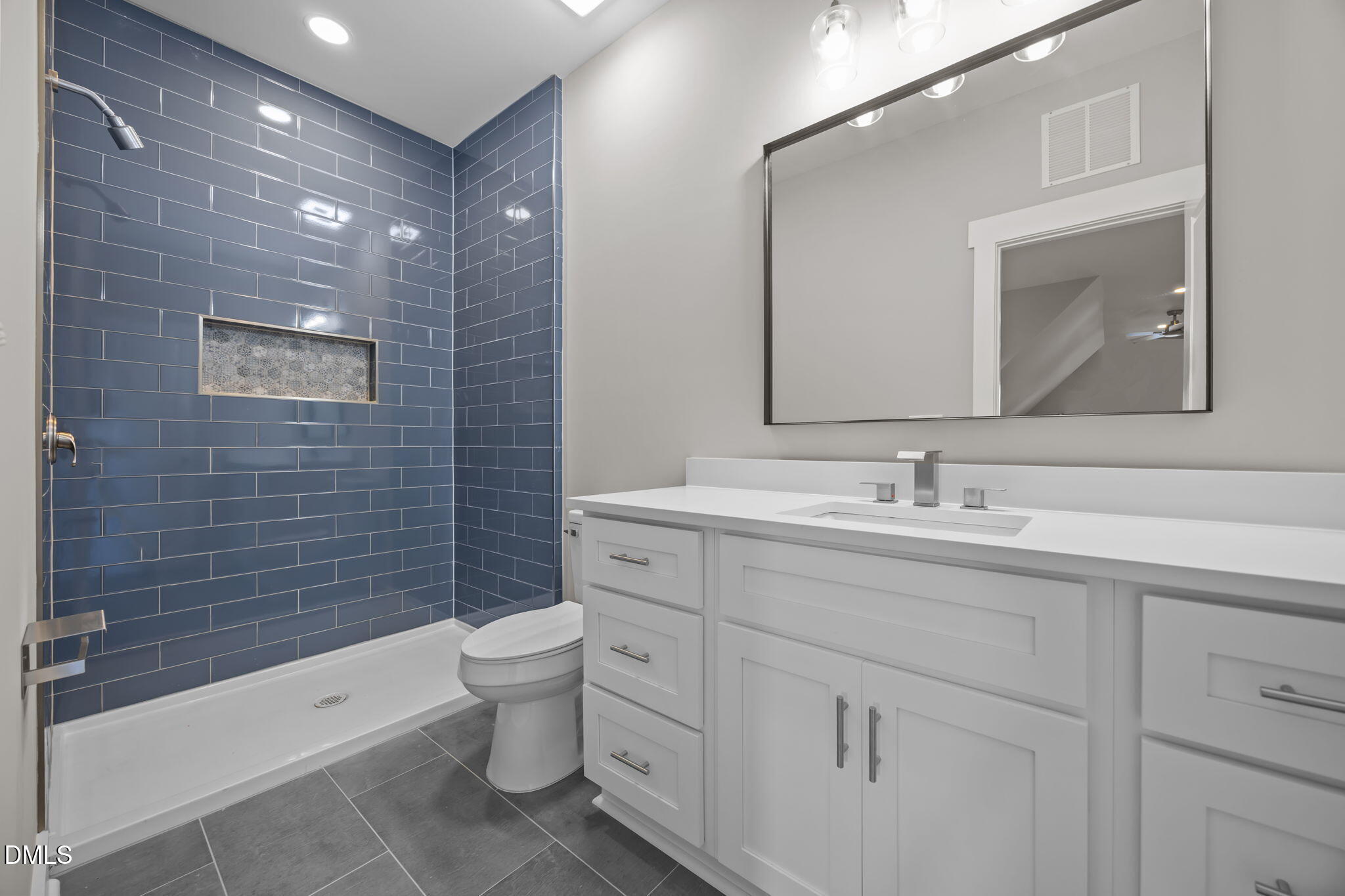 8629 Dukes Lake Road Zebulon, NC 27597 - Photo 34 of 52 a bathroom with a double vanity sink toilet and shower