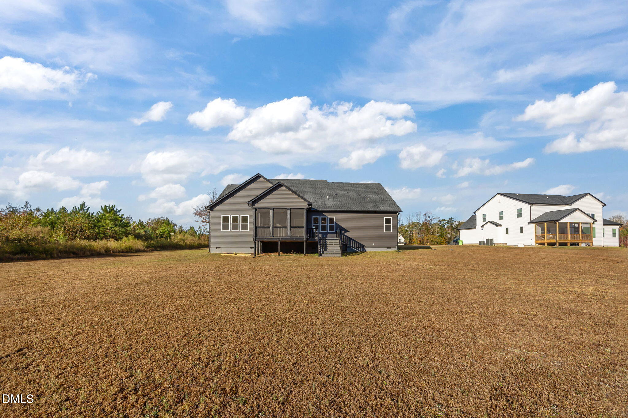 8629 Dukes Lake Road Zebulon, NC 27597 - Photo 40 of 52 a view of a large house with a big yard and large trees
