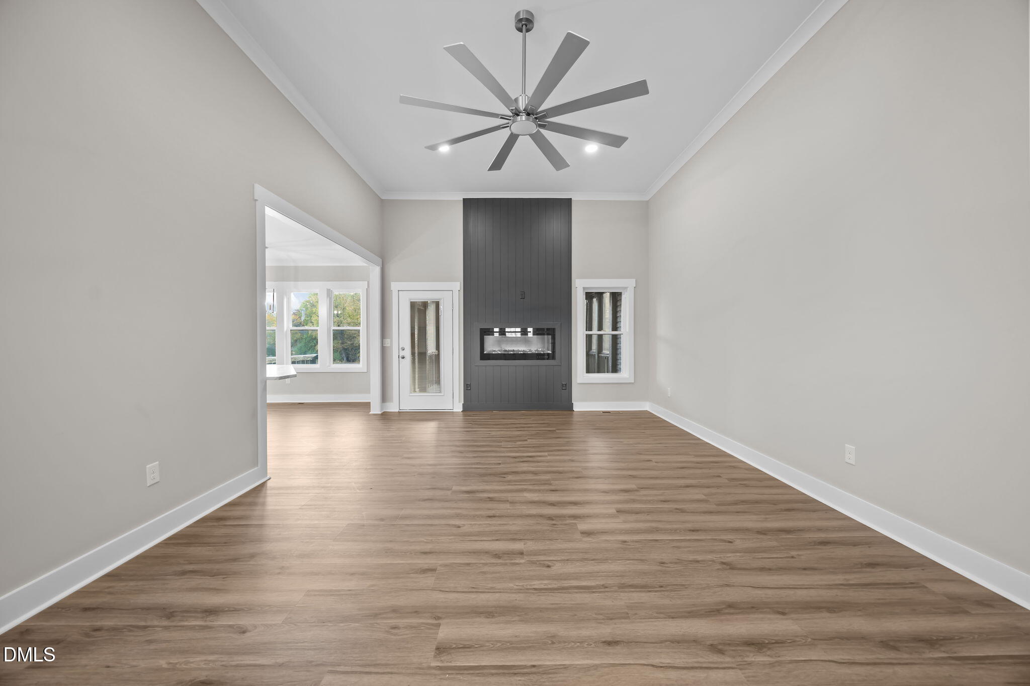 8629 Dukes Lake Road Zebulon, NC 27597 - Photo 7 of 52 a view of an empty room with window and wooden floor