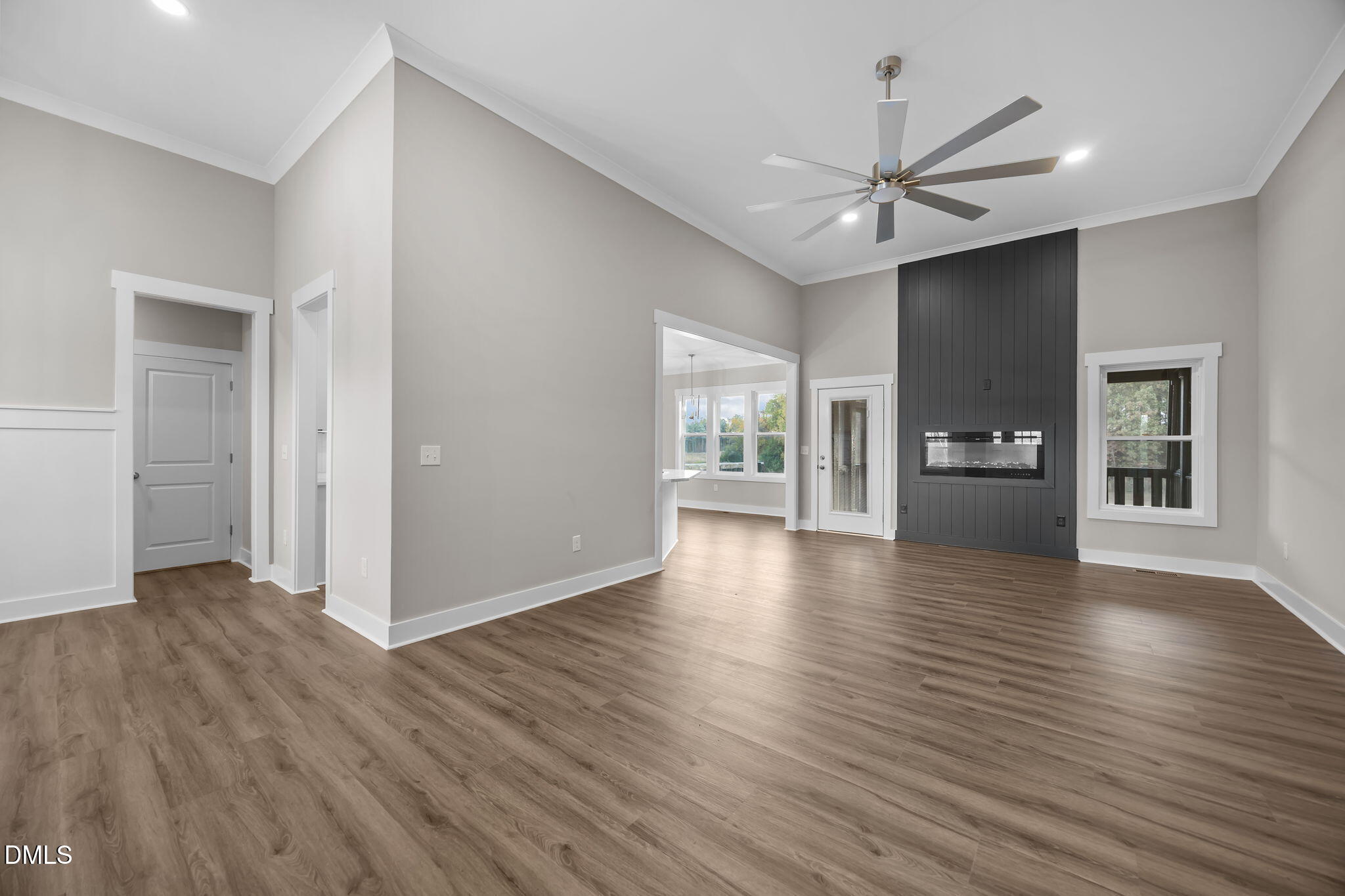 8629 Dukes Lake Road Zebulon, NC 27597 - Photo 8 of 52 a view of an empty room with window and wooden floor