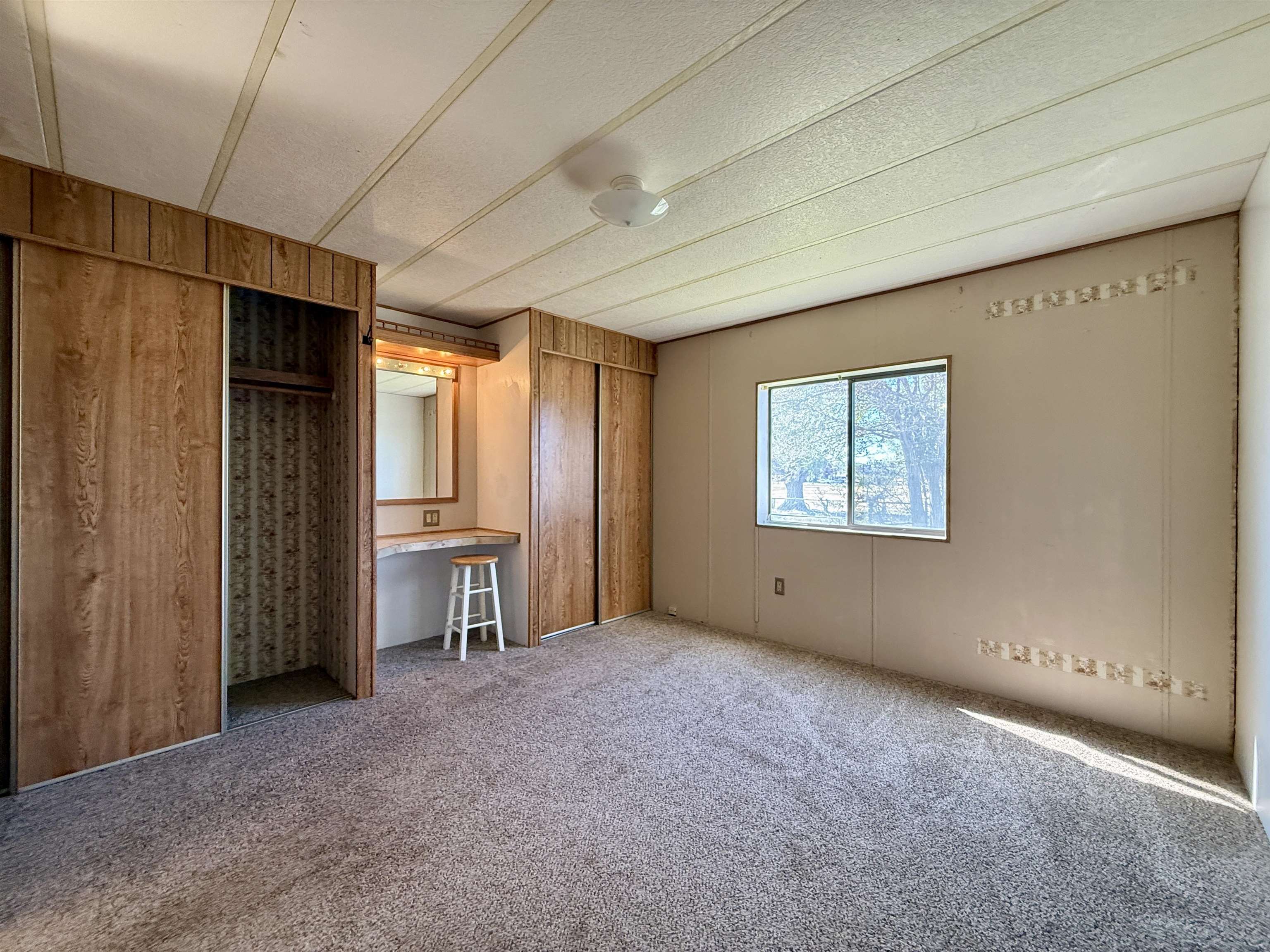 3251 E Road, Unit 33 Clifton, CO 81520 - Photo 19 of 28 an empty room with windows and closet