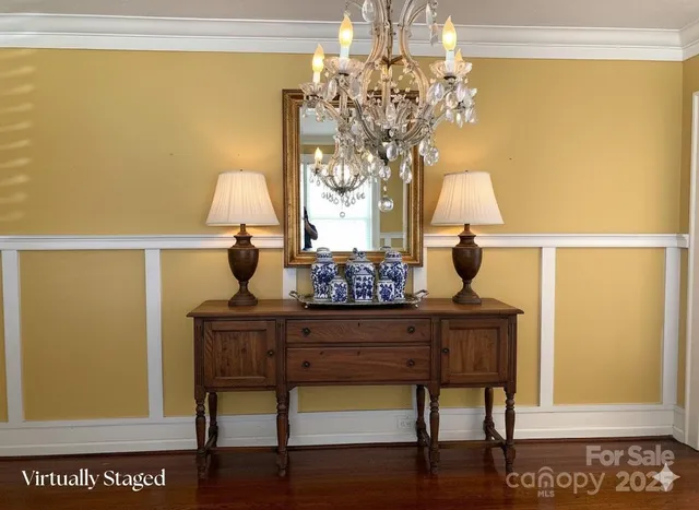 a view of spacious bedroom with a table and chair