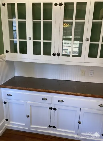 a view of white cabinets with a window