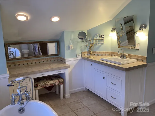 a bathroom with a sink a vanity and a mirror