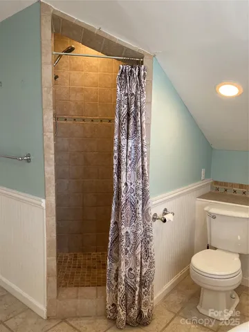 a bathroom with a toilet and shower