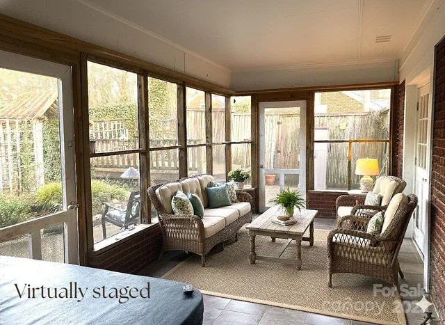 a living room with furniture and floor to ceiling windows