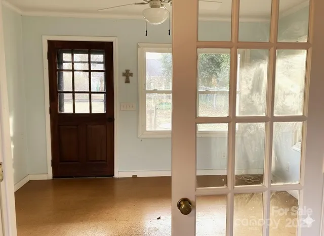 a kitchen with stainless steel appliances granite countertop a refrigerator a sink dishwasher a stove and white countertops with wooden floor