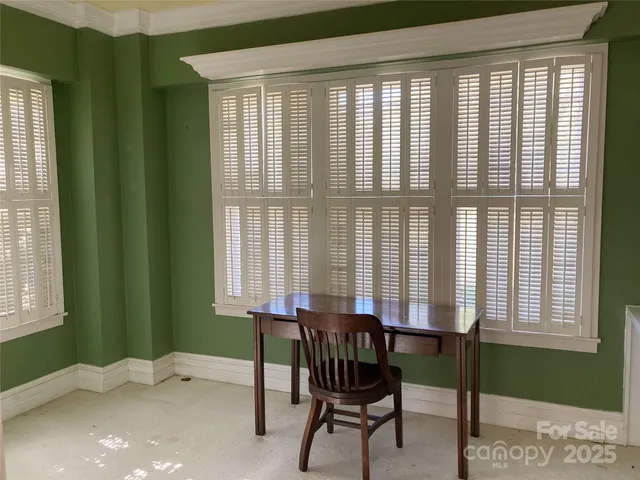 a dining room with furniture and a window