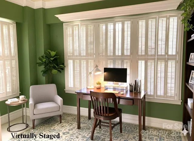 a work room with furniture and a potted plant