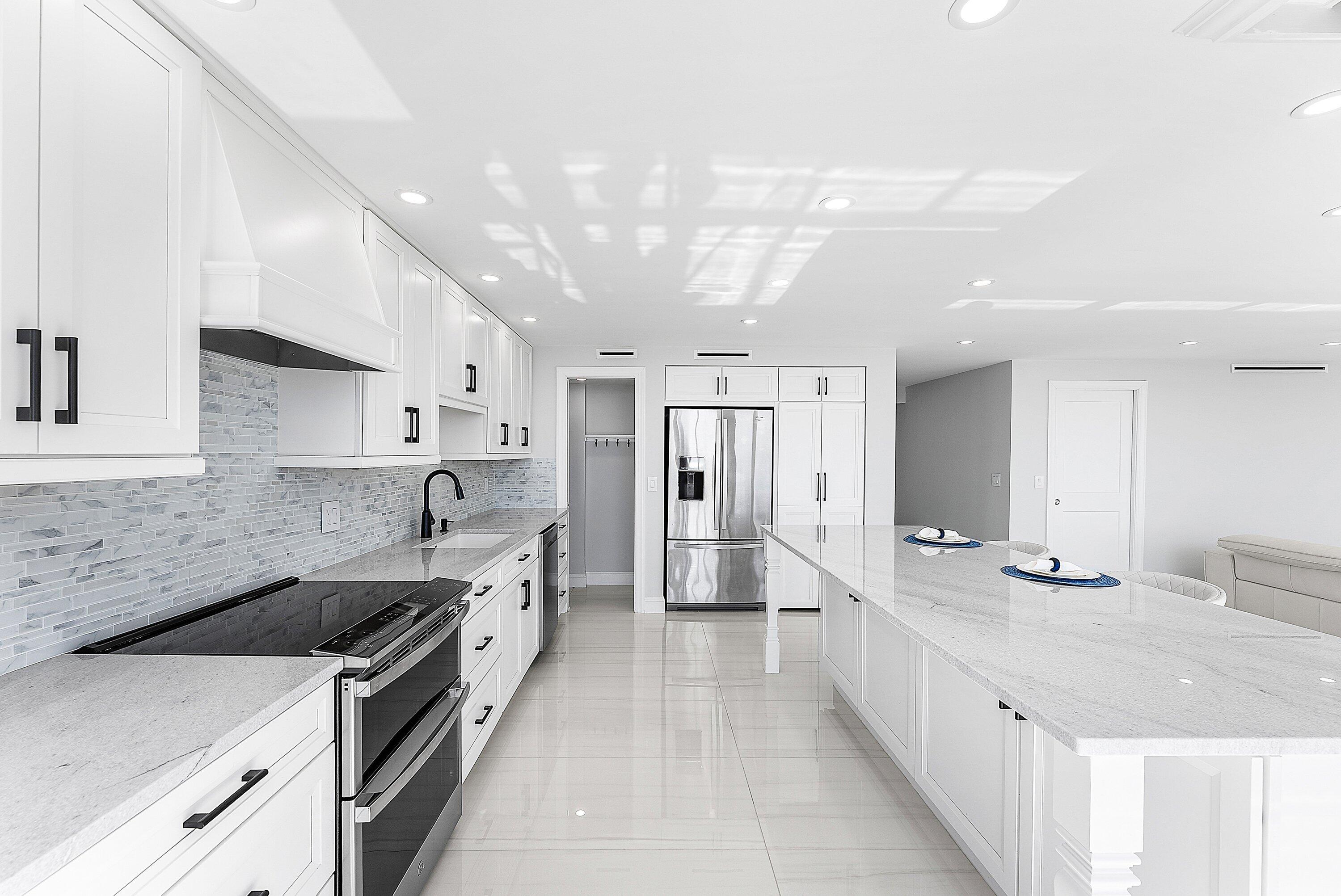 2800 South Ocean Boulevard, Unit 4E Boca Raton, FL 33432 - Photo 12 of 51 a kitchen with stainless steel appliances granite countertop a sink stove and refrigerator