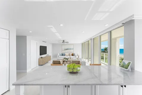 a living room with furniture large window and flat screen tv