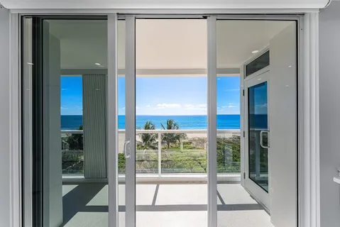 a view of a room with a large window and front door