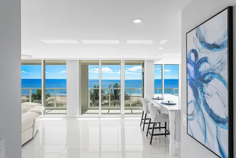 a living room with furniture and a large window with outer view