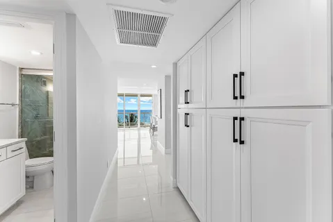 a large bedroom with a bed and glass door