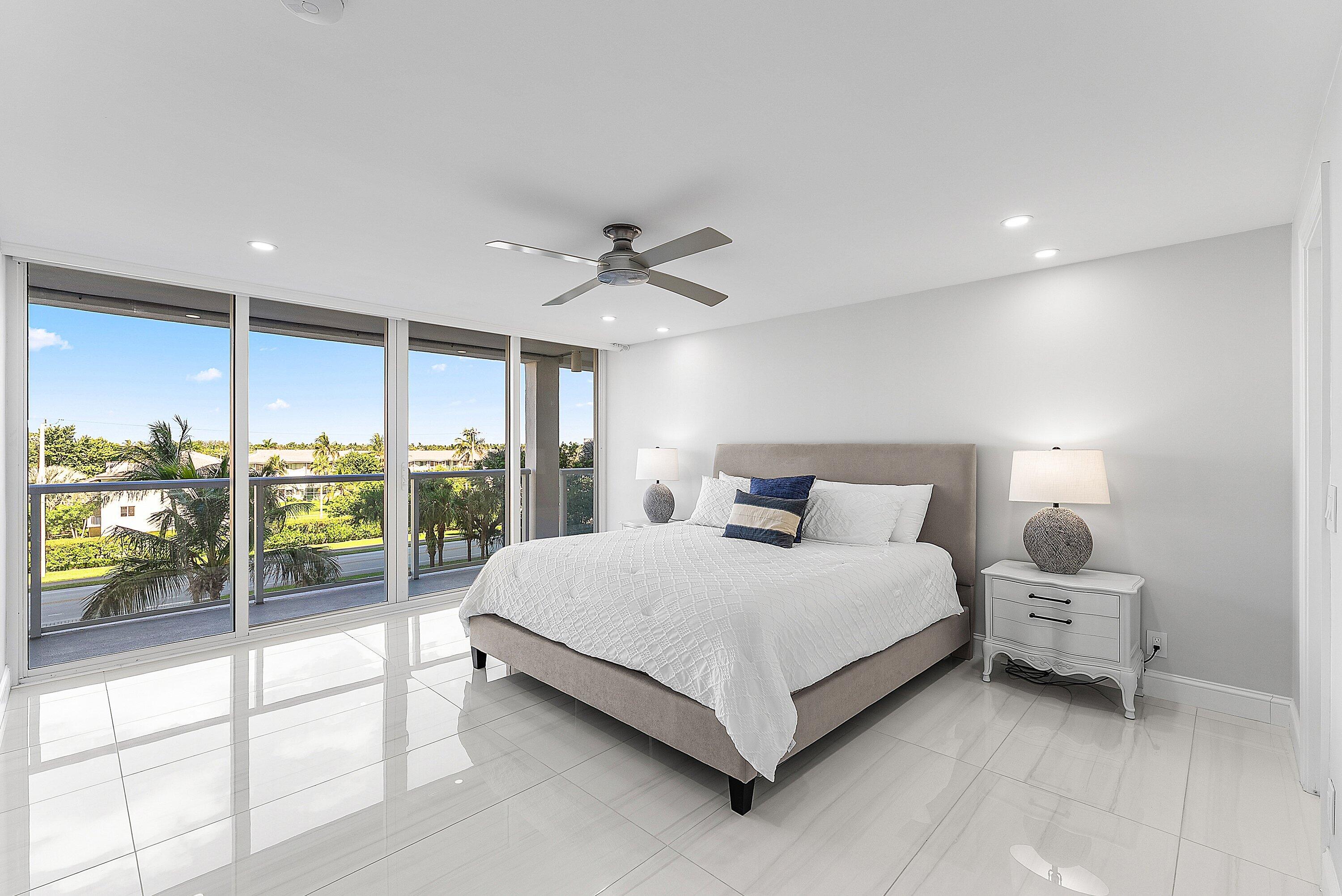 2800 South Ocean Boulevard, Unit 4E Boca Raton, FL 33432 - Photo 21 of 51 a large bedroom with a bed and glass door