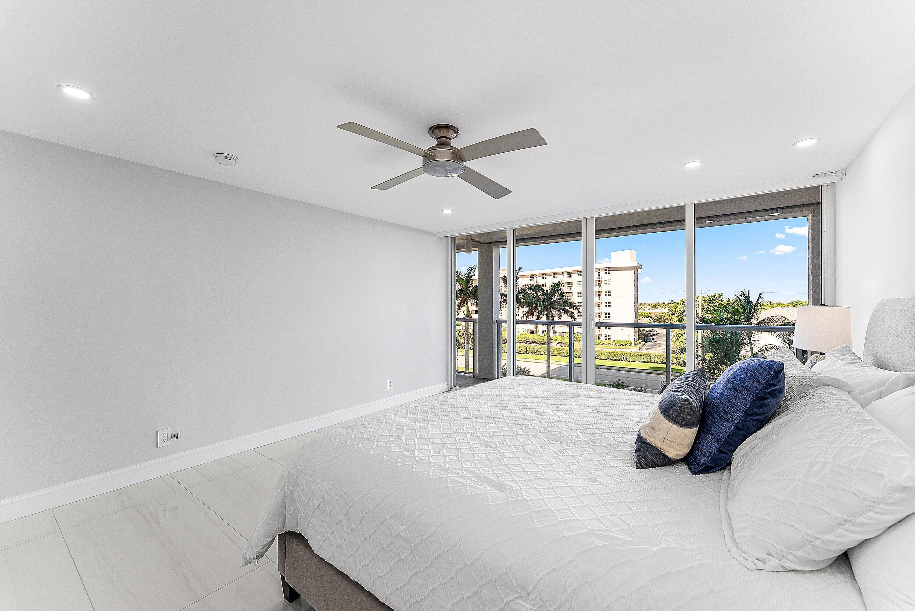 2800 South Ocean Boulevard, Unit 4E Boca Raton, FL 33432 - Photo 22 of 51 a large bedroom with a large bed and ceiling fan