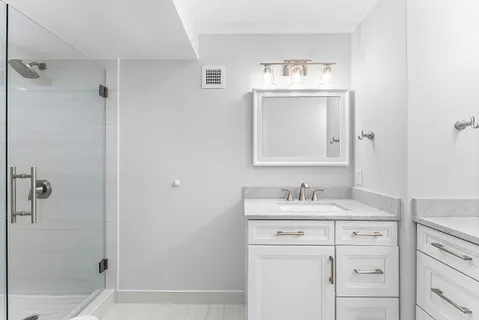 a bathroom with a shower a toilet and a sink