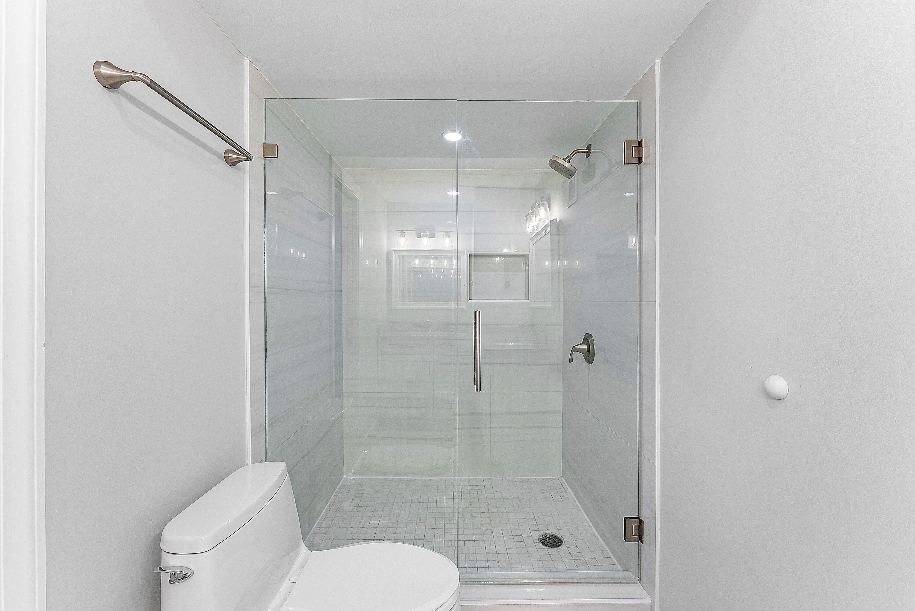 2800 South Ocean Boulevard, Unit 4E Boca Raton, FL 33432 - Photo 25 of 51 a bathroom with a shower a toilet and a sink