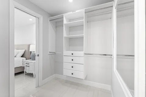 a bedroom with a bed and large window