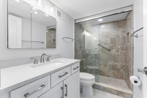 a bedroom with a bed and a wooden floor