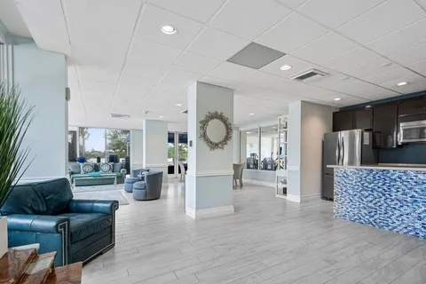 a kitchen with stainless steel appliances granite countertop a refrigerator a sink a stove with wooden floor