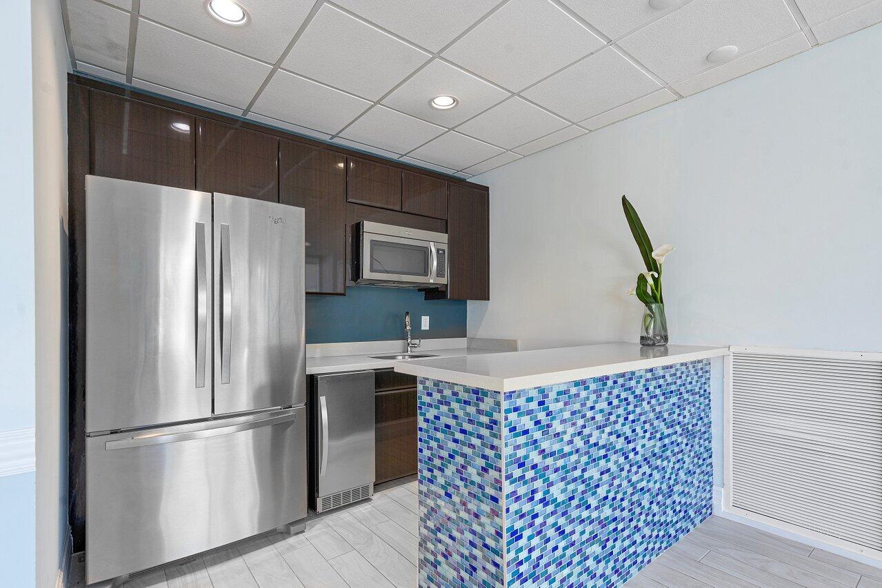 2800 South Ocean Boulevard, Unit 4E Boca Raton, FL 33432 - Photo 44 of 51 a kitchen with stainless steel appliances granite countertop a refrigerator a sink a stove with wooden floor